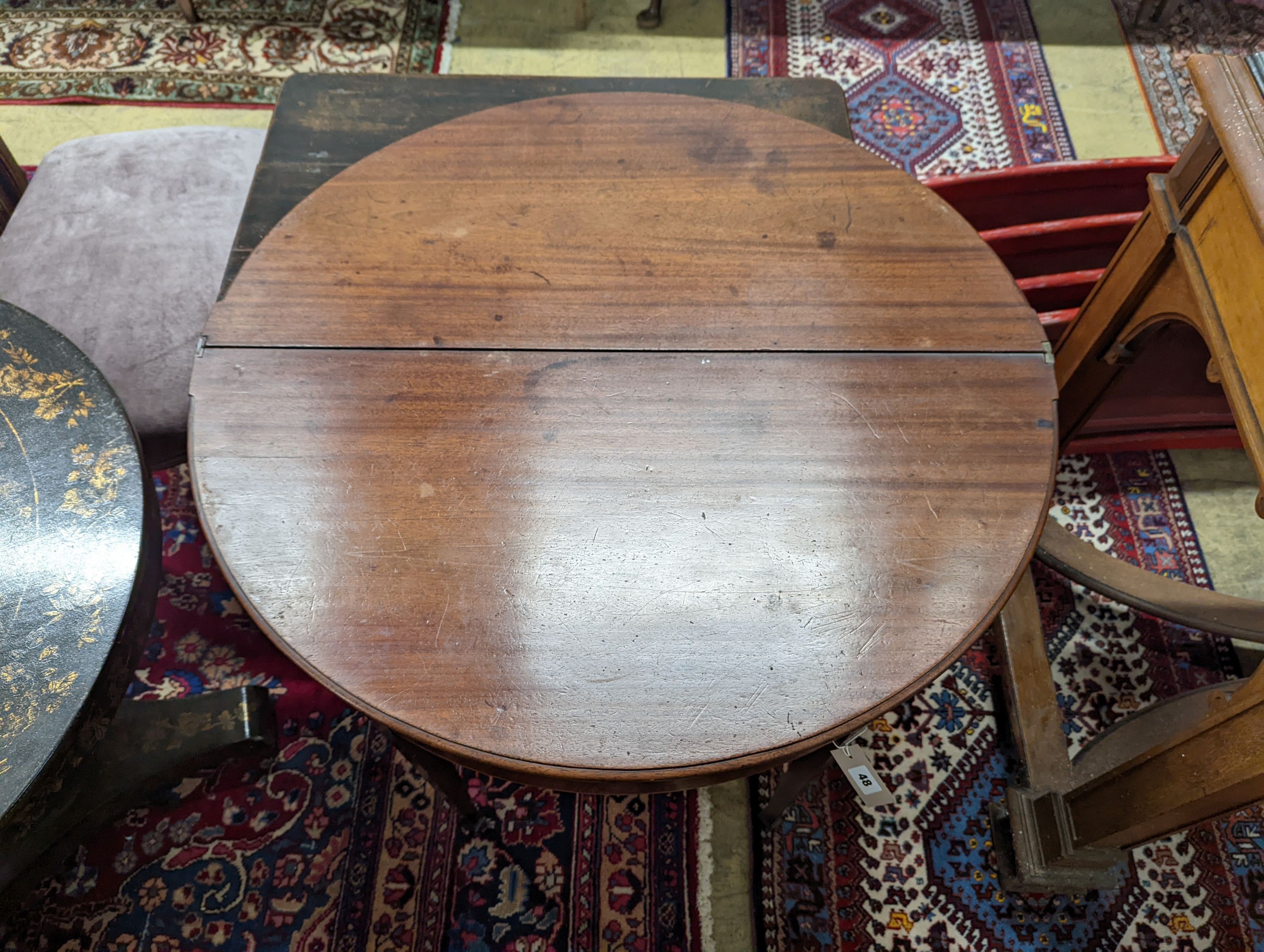 A George III mahogany demi lune tea table. W-90, D-44, H-73cm.